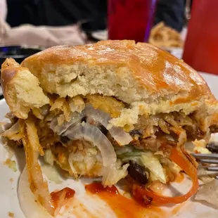 a half eaten sandwich on a plate