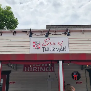a little girl standing in front of a restaurant