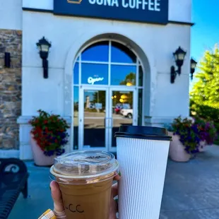 a person holding a cup of coffee