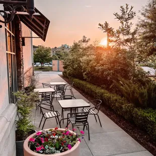 a patio with tables and chairs
