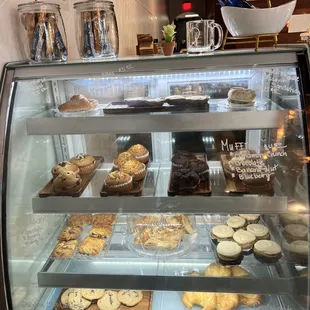 a display case filled with cookies and pastries