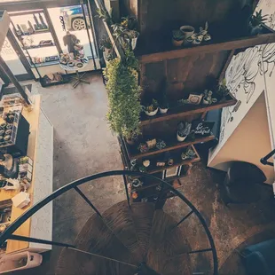 Very cool spiral staircase to a cozy upstairs seating area.