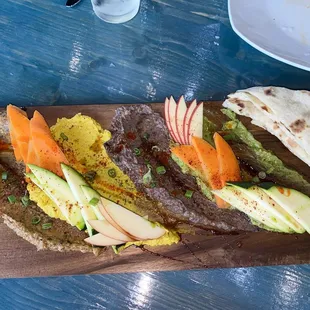 Spread Feast: Babaganoush, hummus, bean, and avocado with thinly sliced fresh veggies and bread