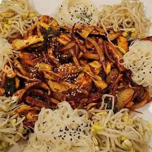 a plate of noodles with meat and vegetables