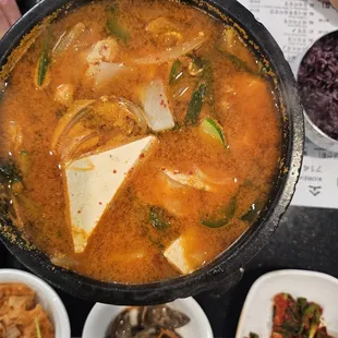 a bowl of soup with tofu and vegetables