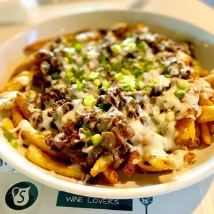 Poutine - shaved rib eye, beer battered fries, gravy, mozzarella and green onions.  Thank god we got the full order!!!