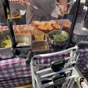 a man preparing food on a cart
