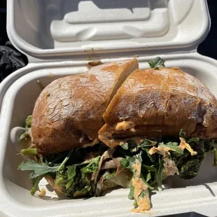 a sandwich in a styrofoam container