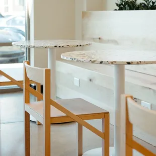 two tables and a bench in a coffee shop