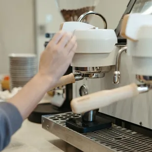 a person using a coffee machine