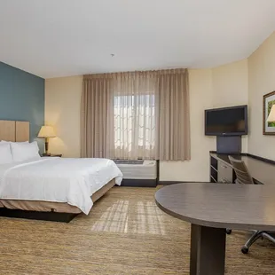 Fully furnished apartment style Studio Suite with large workspace, leather recliner and executive chair.