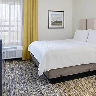 Fully furnished apartment style Studio Suite with large workspace, leather recliner and executive chair.