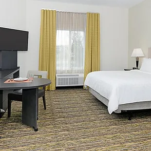 Fully furnished apartment style Studio Suite with large workspace, leather recliner and executive chair.