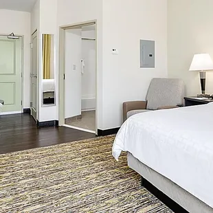 Fully furnished apartment style Studio Suite with large workspace, leather recliner and executive chair.