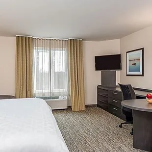 Fully furnished apartment style Studio Suite with large workspace, leather recliner and executive chair.