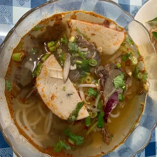 a bowl of soup with meat and vegetables