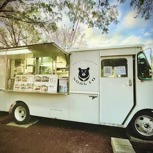 a white food truck parked in a parking lot