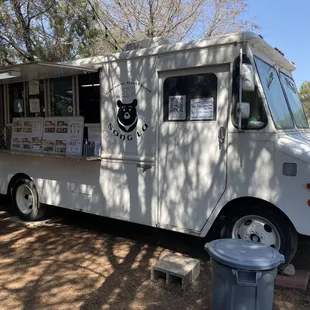 a food truck parked in the shade