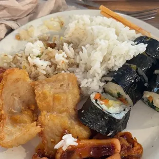 a plate of food with rice, meat, and vegetables
