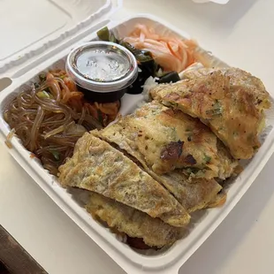 Mixed plate meat jun and spicy chicken with long rice, kimchi, seaweed, and daikon.