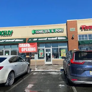 two cars parked in front of a store