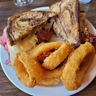 a grilled cheese sandwich with onion rings