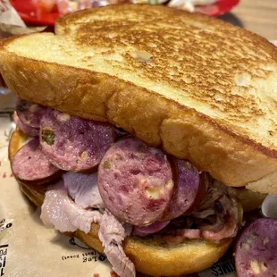 The Whole Hog- Sliced Pork, Pulled Pork &amp; Jalapeño Cheddar Sausage w/ Sweet BBQ sauce on garlic bread