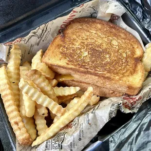 Brisket Grilled Cheese on garlic toast w/ Crinkle Cut Fries (fries were ok). Drink, Mustard BBQ and Sizzlin&apos; Sweet BBQ not shown.