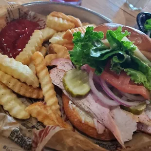 Yumn!!  Turkey on a buttered toasted roll with lettuce, onions, and pickle.