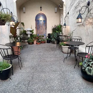 a courtyard with tables and chairs