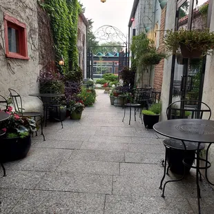 a patio with tables and chairs