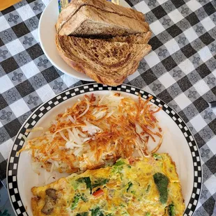 an omelet, toast, and hash browns
