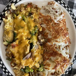 Veggie Scrambler - Three eggs scrambled with onions, peppers, mushrooms, diced tomatoes, broccoli and spinach, topped with cheddar cheese