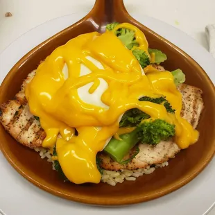 Smother chicken with broccoli and cheese over rice