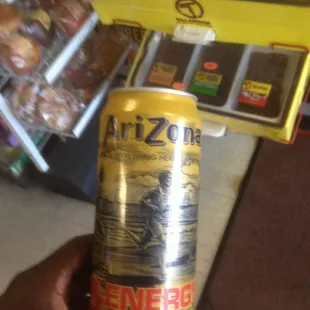 a person holding a can of energy drink