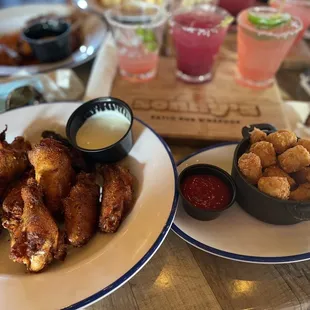 Happy table! Magical dry rub wings, tots and flight of margaritas! What else do you need!