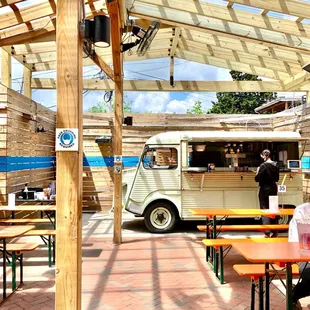 a food truck parked under a pergol roof