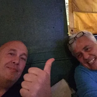 two men with thumbs up