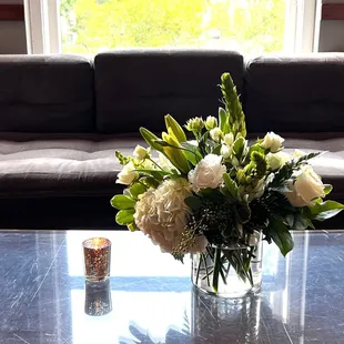 a vase of flowers on a coffee table