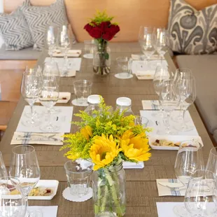 Inside table set for a wine and cheese tasting with 5 wines.