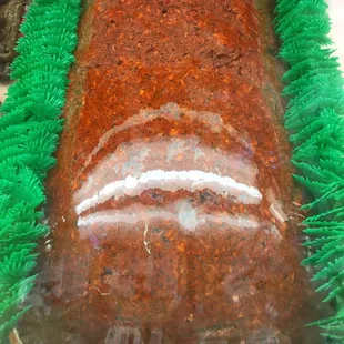 a large carrot cake with green grass