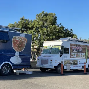 two food trucks parked in a parking lot