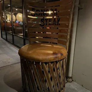 a wooden chair in front of a window