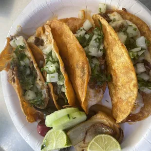 three tacos on a paper plate