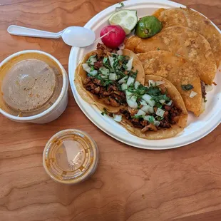 Tacos (al pastor and chorizo), quesabirria, consomme, and sauce