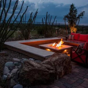 a patio with a fire pit