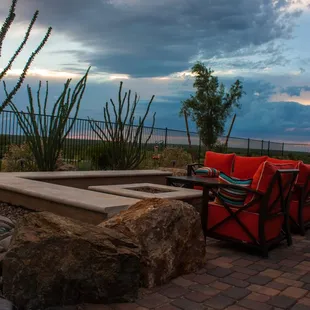 a patio with a fire pit
