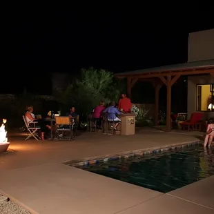 people sitting around a fire pit