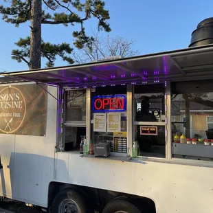 a food truck with a purple canopy