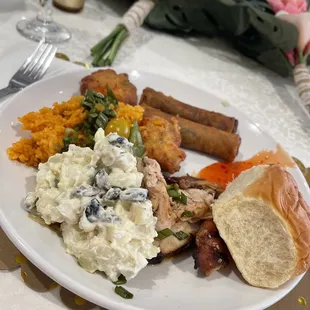 Shrimp Pattie's, lumpia, red rice, finadeni, roasted pig, teriyaki chicken by Sons of Guam